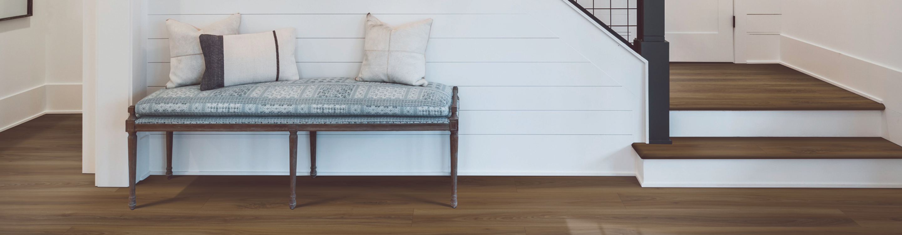 waterproof wood look flooring in bathroom with white tub